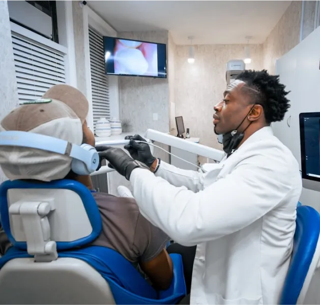 Picture of Dr. Aguebor doing a comprehensive exam